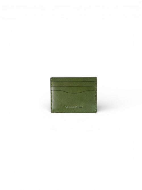 Green leather cardholder on a white background