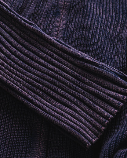 Close-up of a dark blue ribbed sweater collar