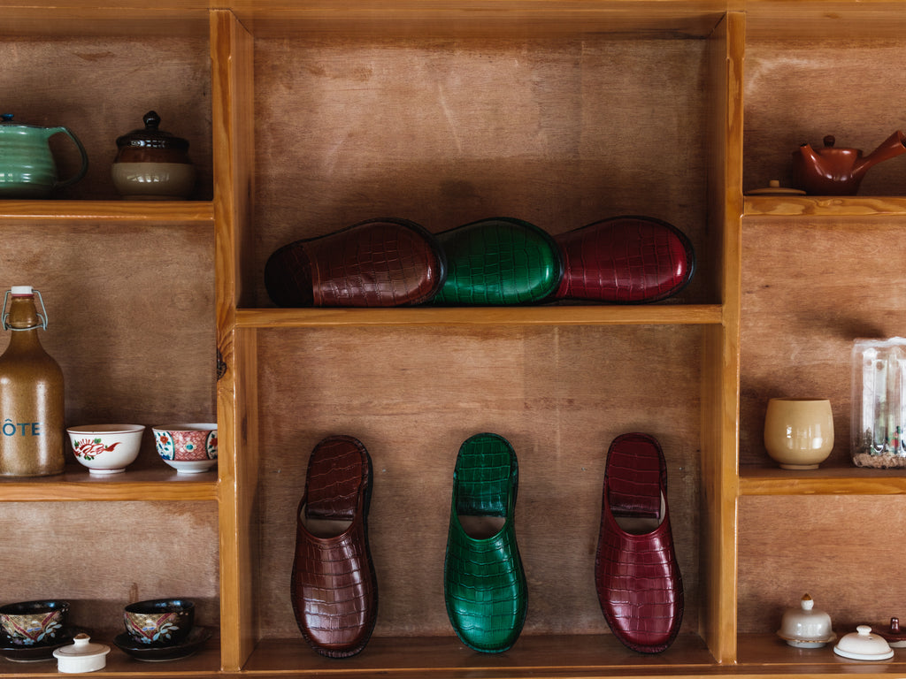 Wooden shelves with various items including shoes and ceramicware.