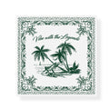 A square graphic design in green and white featuring a tropical beach scene in the center. It shows two beach chairs under coconut palm trees, a coconut on the ground, and a sailboat in the ocean. Above the scene, the phrase “Vibe with the Legends” is written in elegant script. The border is decorated with ornate floral and vine patterns, giving the image a vintage, postcard-like feel.