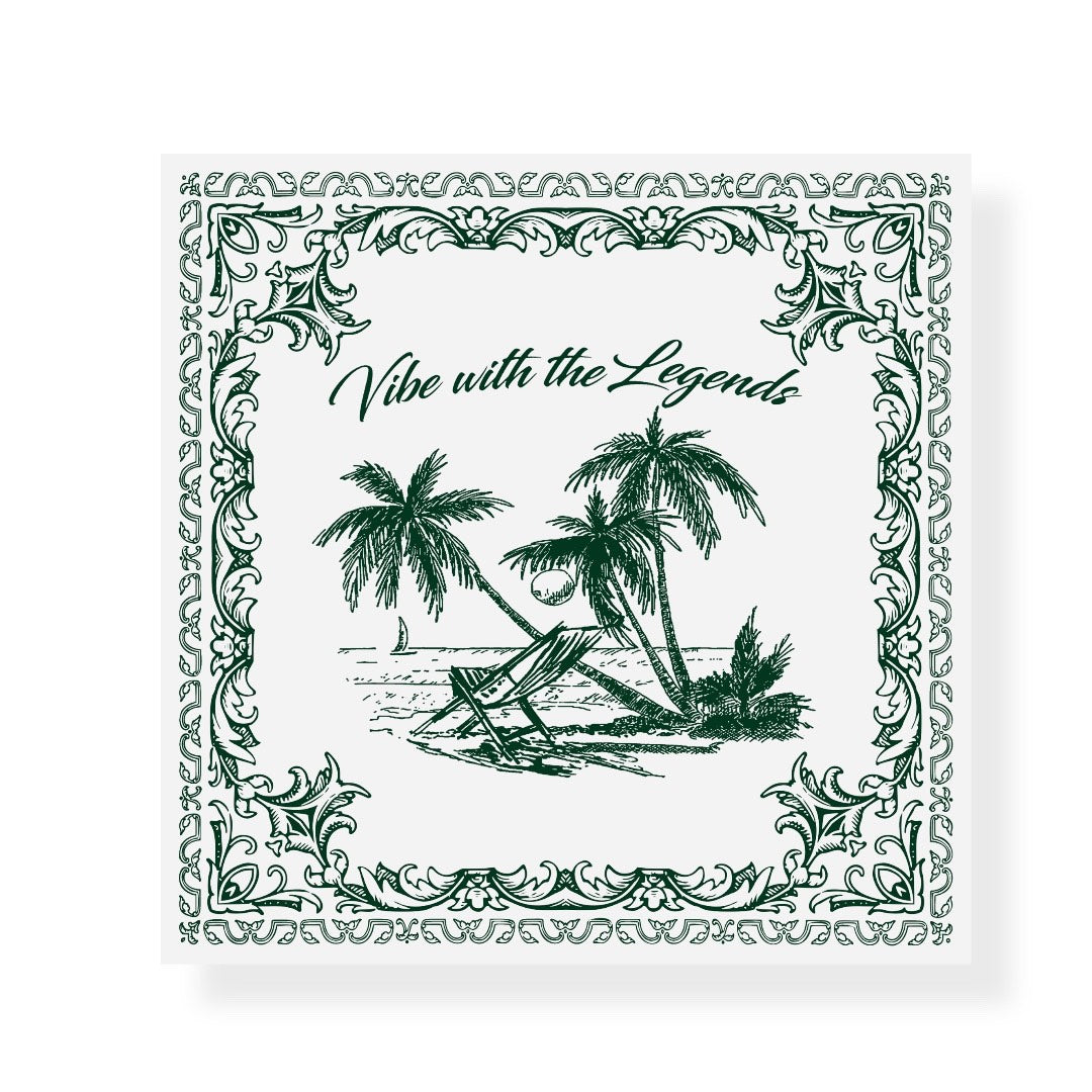 A square graphic design in green and white featuring a tropical beach scene in the center. It shows two beach chairs under coconut palm trees, a coconut on the ground, and a sailboat in the ocean. Above the scene, the phrase “Vibe with the Legends” is written in elegant script. The border is decorated with ornate floral and vine patterns, giving the image a vintage, postcard-like feel.