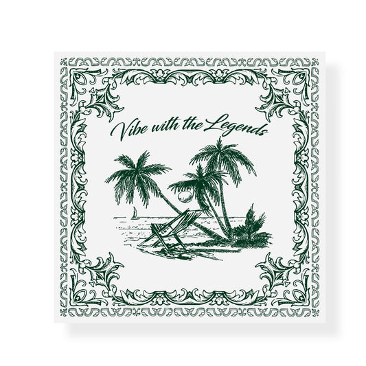 A square graphic design in green and white featuring a tropical beach scene in the center. It shows two beach chairs under coconut palm trees, a coconut on the ground, and a sailboat in the ocean. Above the scene, the phrase “Vibe with the Legends” is written in elegant script. The border is decorated with ornate floral and vine patterns, giving the image a vintage, postcard-like feel.